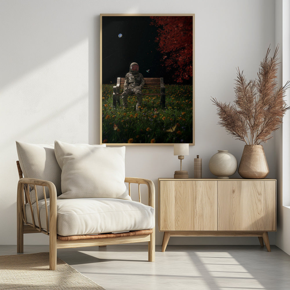 A surreal scene depicting an astronaut in a full spacesuit sitting alone on a wooden park bench in a vibrant field of wildflowers under a starry night sky. The planet Earth is visible in the distance, and a large tree with red leaves frames the right side of the image. Poster