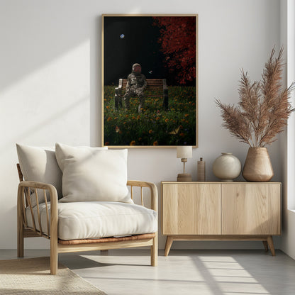 A surreal scene depicting an astronaut in a full spacesuit sitting alone on a wooden park bench in a vibrant field of wildflowers under a starry night sky. The planet Earth is visible in the distance, and a large tree with red leaves frames the right side of the image. Poster