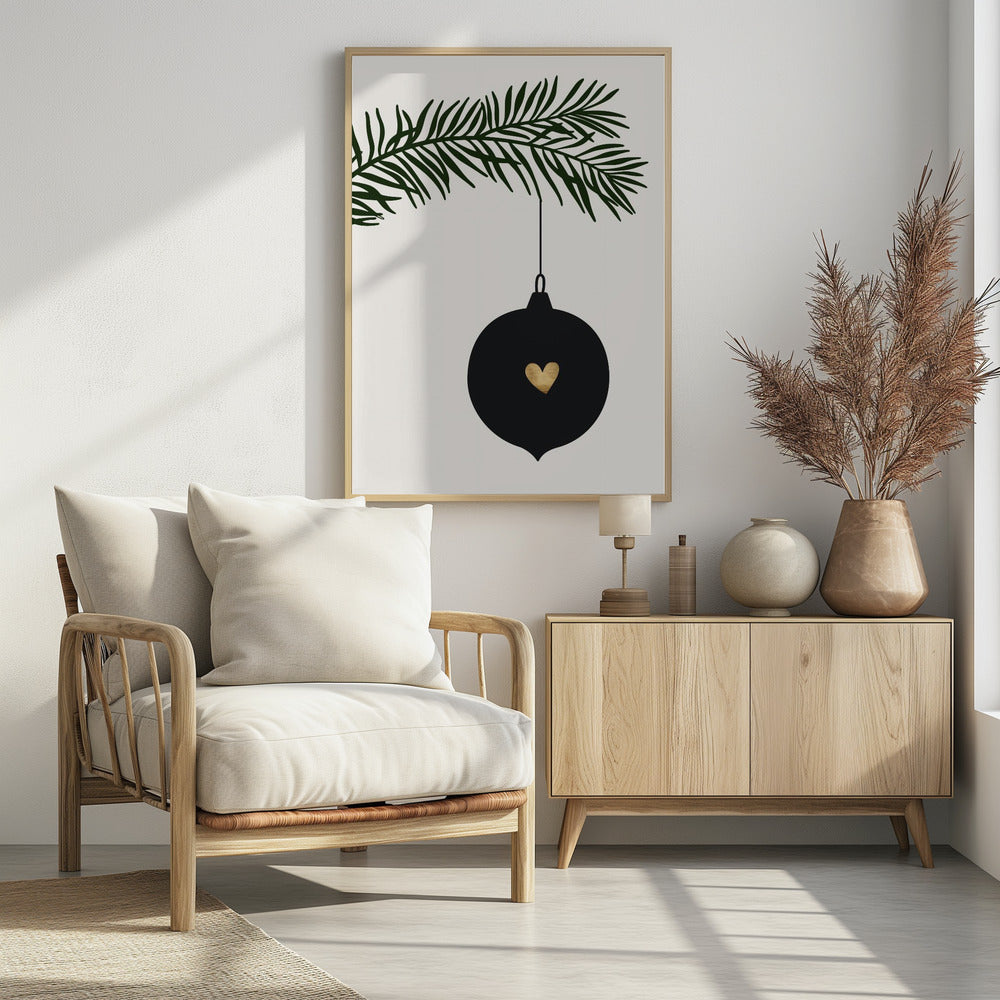 A minimalist digital illustration of a black Christmas ornament with a small gold heart in the center, hanging from a dark green pine branch against a cream-colored background, all enclosed in a thin black frame. Artwork