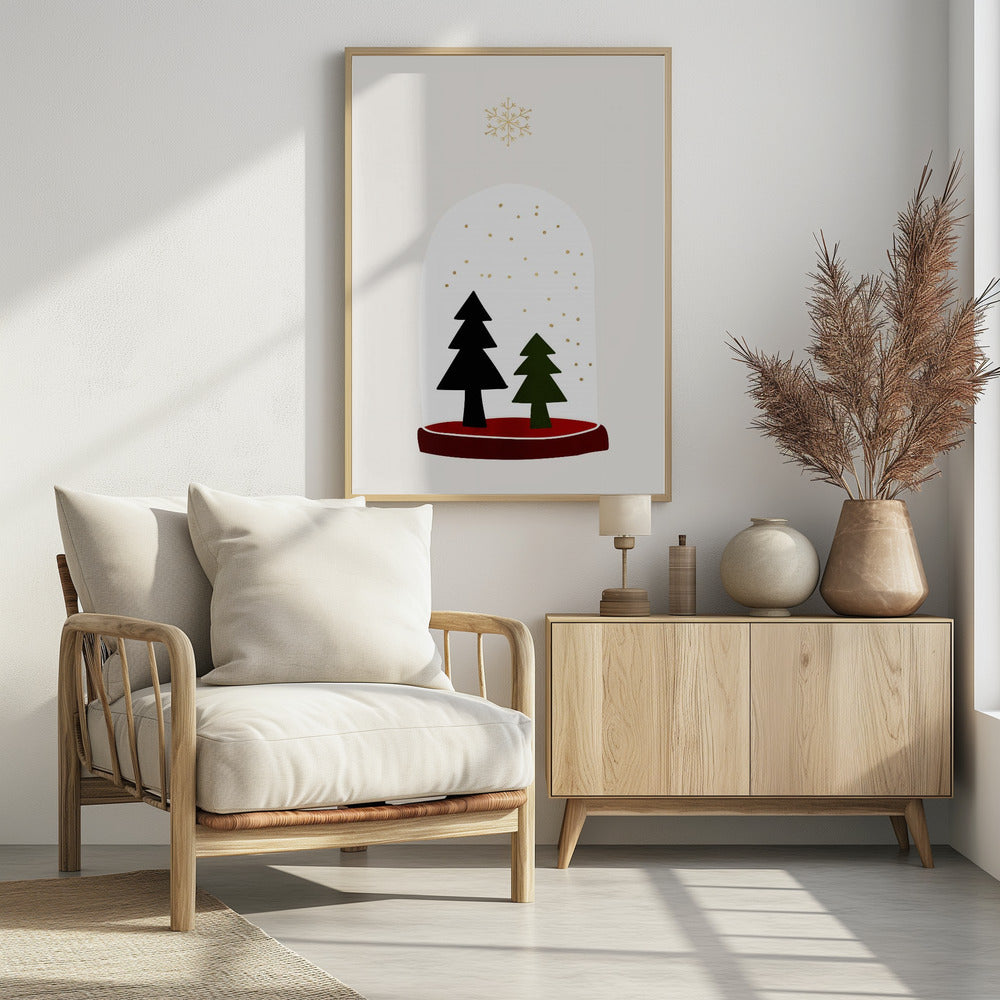 A minimalist illustration of a snow globe against an off-white background. Inside the globe are two simple evergreen trees, one black and one green, with gold dots falling like snow. The globe has a red base, and a single large gold snowflake floats above it. The artwork is enclosed in a thin black frame. Decor