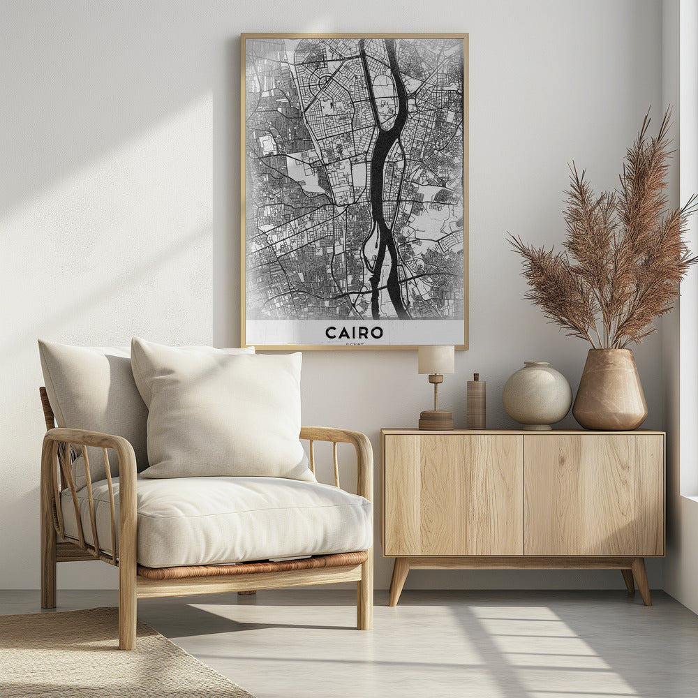 A minimalist black and white framed poster of a street map of Cairo. The Nile River flows vertically through the center of the detailed city grid. The word 'CAIRO' is printed in a bold, black, sans-serif font at the bottom. Decor