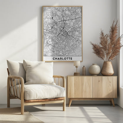 A minimalist black and white map of Charlotte, North Carolina, displayed in a black frame. The map details the intricate network of city streets and highways. At the bottom, a white banner features the city's name 'CHARLOTTE' in a bold, black, sans-serif font. Poster