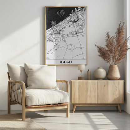 A minimalist black and white map of Dubai in a black frame. The water is depicted in black with a subtle texture, while the land is white, showing the city's road network in thin black lines. Key features like the Palm Jumeirah and The World Islands are visible off the coast. The word 'DUBAI' is written in a bold, black, sans-serif font at the bottom. Decor