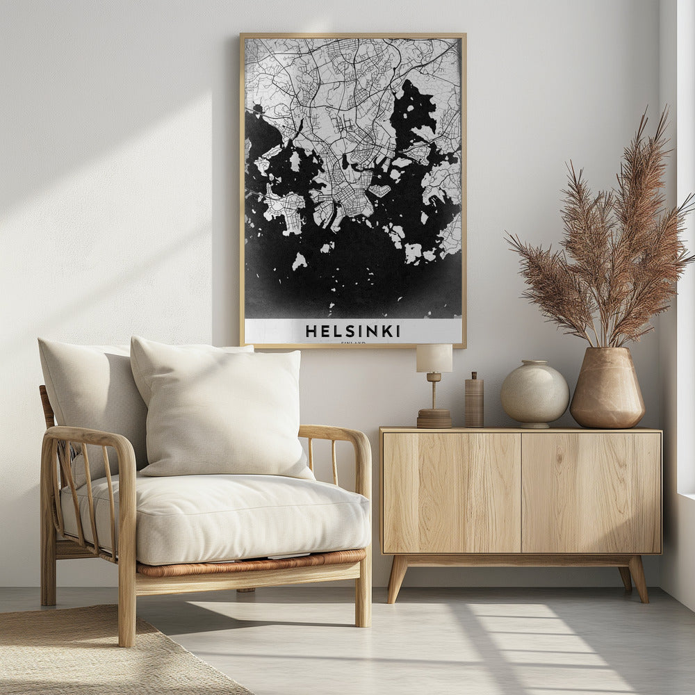 A modern black and white map of Helsinki, Finland, presented in a black frame. The city's street grid is detailed in white lines on a textured black background representing the water, creating a high-contrast, minimalist design. The name 'HELSINKI' is printed in bold capital letters at the bottom on a white banner. Artwork