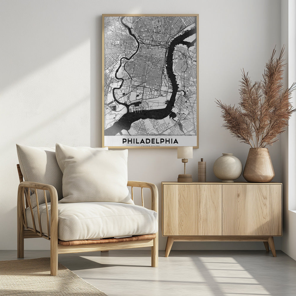 A modern black and white framed poster of a city map of Philadelphia. The map details the street grid, with the Schuylkill and Delaware rivers prominently featured in solid black. The word 'PHILADELPHIA' is printed in a bold, black sans-serif font at the bottom. Artwork