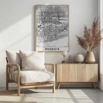 A minimalist black and white street map of Phoenix, Arizona, presented in a black frame. The map features a dense grid of roads on a lightly textured white background, with the city's name 'PHOENIX' printed in large, black capital letters at the bottom. Wall Art