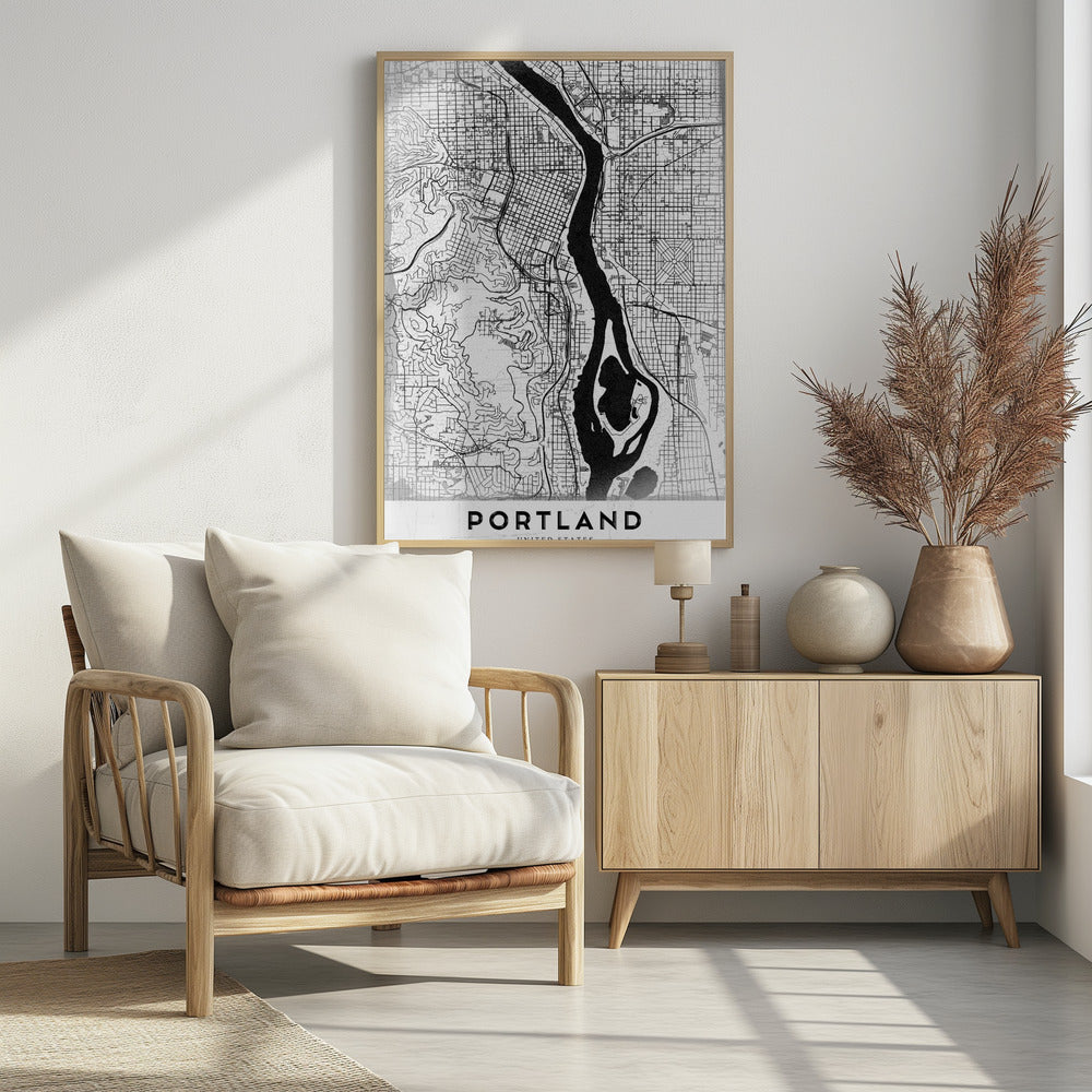 A framed, black and white street map of Portland, Oregon. The map is stylized with black lines for streets on a textured white background, and the Willamette River is depicted in solid black. The word 'PORTLAND' is written in a bold, black, sans-serif font at the bottom. Decor