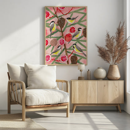 A festive illustration of a pine branch against a pink background, decorated with chickadees, pinecones, slices of red grapefruit, a red apple, and a red beaded garland. The scene has a light dusting of snow, creating a whimsical winter or holiday feel. Decor
