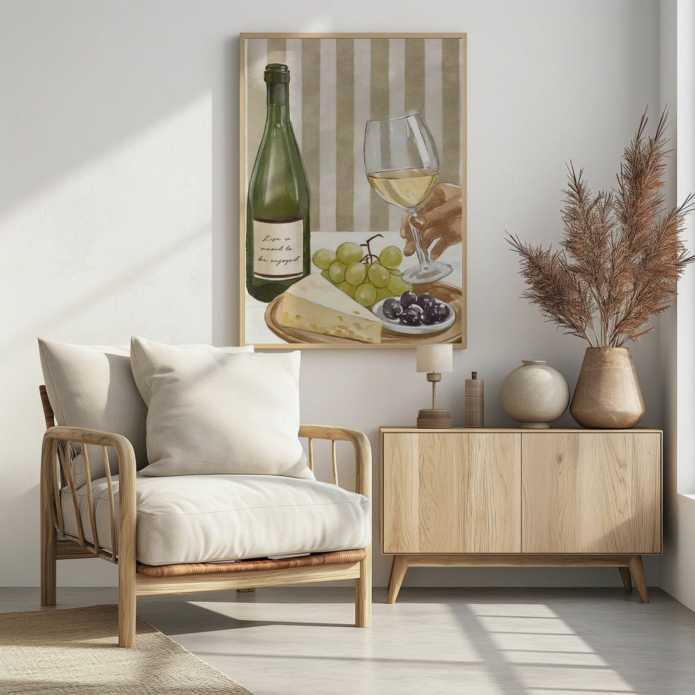 A still life painting of a classic wine and cheese spread. It features a green bottle of white wine with the words 'Life is meant to be enjoyed' on the label, a hand holding a wine glass, a wedge of cheese, green grapes, and black olives, all set against a striped beige and white background. Artwork
