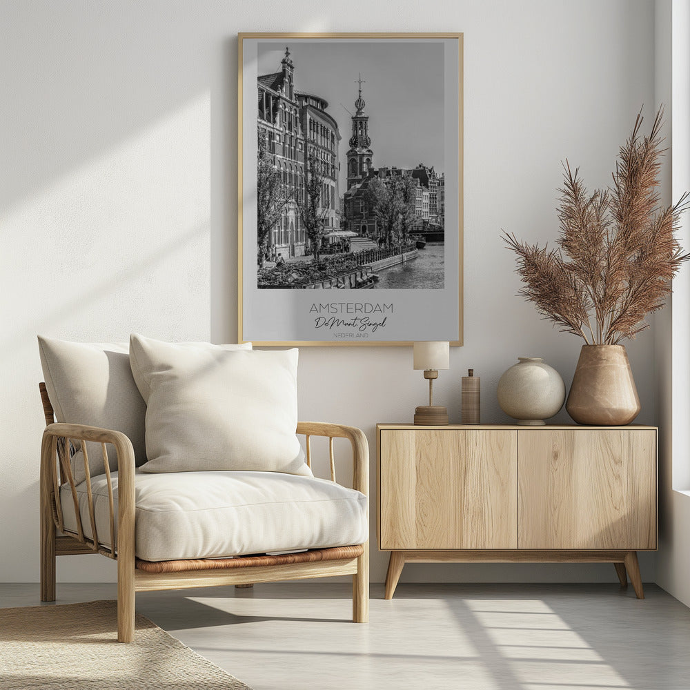 A black and white travel poster of Amsterdam, Netherlands. The photo shows the Munttoren clock tower and traditional Dutch buildings along the Singel canal. A floating barge filled with bicycles is in the foreground. The poster has a white border with the text 'AMSTERDAM', 'De Munt, Singel', and 'NEDERLAND' at the bottom. Artwork
