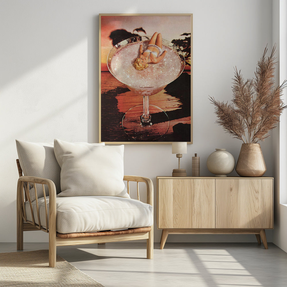 A surreal collage featuring a blonde woman in a white bikini lounging in a giant cocktail glass filled with a sparkling pink liquid, set against a warm sunset over the ocean. Print