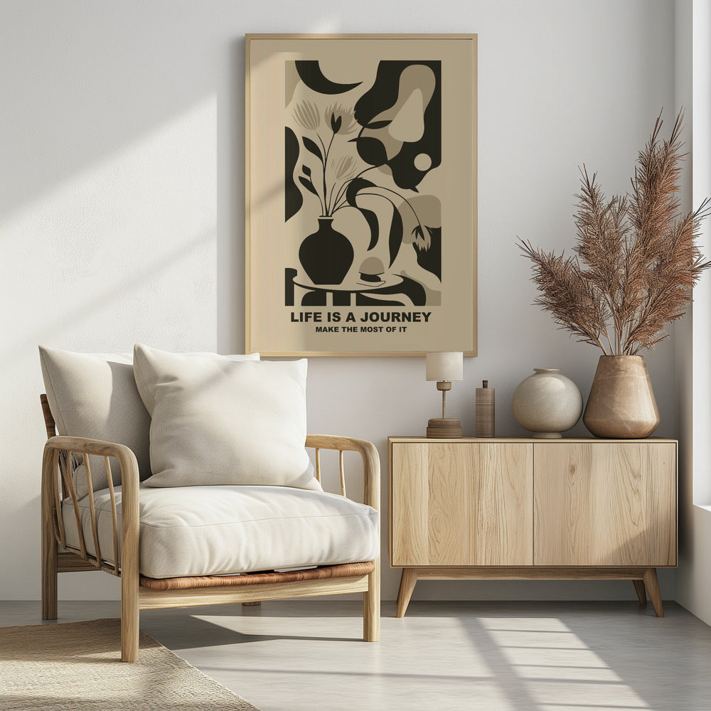 A framed abstract art print in a neutral color palette. It depicts a stylized still life with a dark vase of flowers on a table, set against a background of large, organic shapes in beige, taupe, and dark brown. Below the image, the motivational quote 'LIFE IS A JOURNEY' and 'MAKE THE MOST OF IT' is printed in a bold, dark font. Artwork