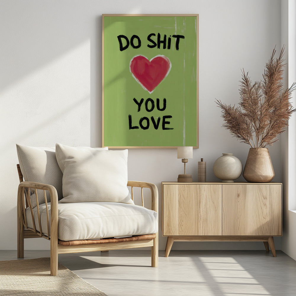 A framed modern art print with a light green background featuring the motivational phrase 'DO SHIT YOU LOVE' in black, hand-painted letters. A large, stylized red heart is painted between the top and bottom lines of text. Print