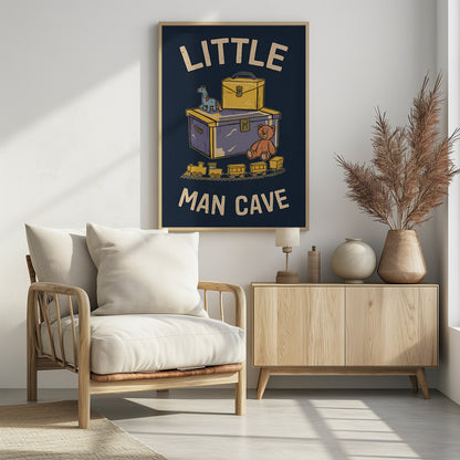 A framed vintage-style illustration with the text 'LITTLE MAN CAVE' on a dark blue background. The artwork features classic toys, including a toy chest, a teddy bear, a toy train on tracks, and a small horse on wheels. Decor