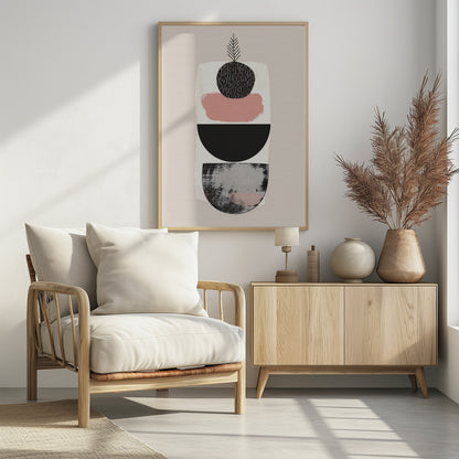 A modern abstract art piece with a vertical composition against a beige background. It features a stack of shapes: a textured black and grey semi-circle at the bottom, a solid black semi-circle, a splotch of muted pink paint, and a textured black circle at the top from which a simple black line drawing of a leaf emerges. The entire piece is in a black frame. Decor