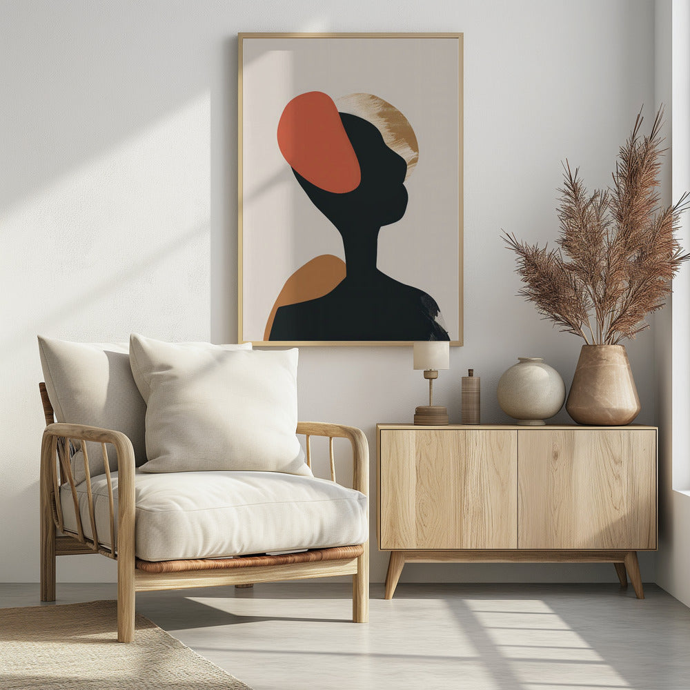 An abstract art print in a black frame featuring the silhouette of a person's head and shoulders against a light beige background. The black silhouette is overlaid with large, organic shapes in burnt orange, ochre, and a textured gold. Decor