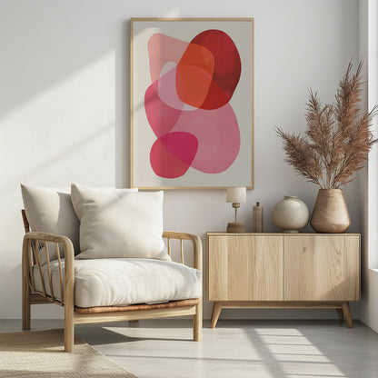 An abstract art print in a black frame, featuring a composition of overlapping, translucent, organic shapes in shades of red, orange, and pink on an off-white background. Print