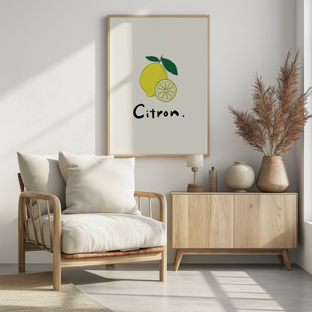 A minimalist art print in a black frame featuring a yellow lemon with green leaves and a lemon slice. Below the illustration, the word 'Citron.' is written in a simple black font against an off-white background. Artwork