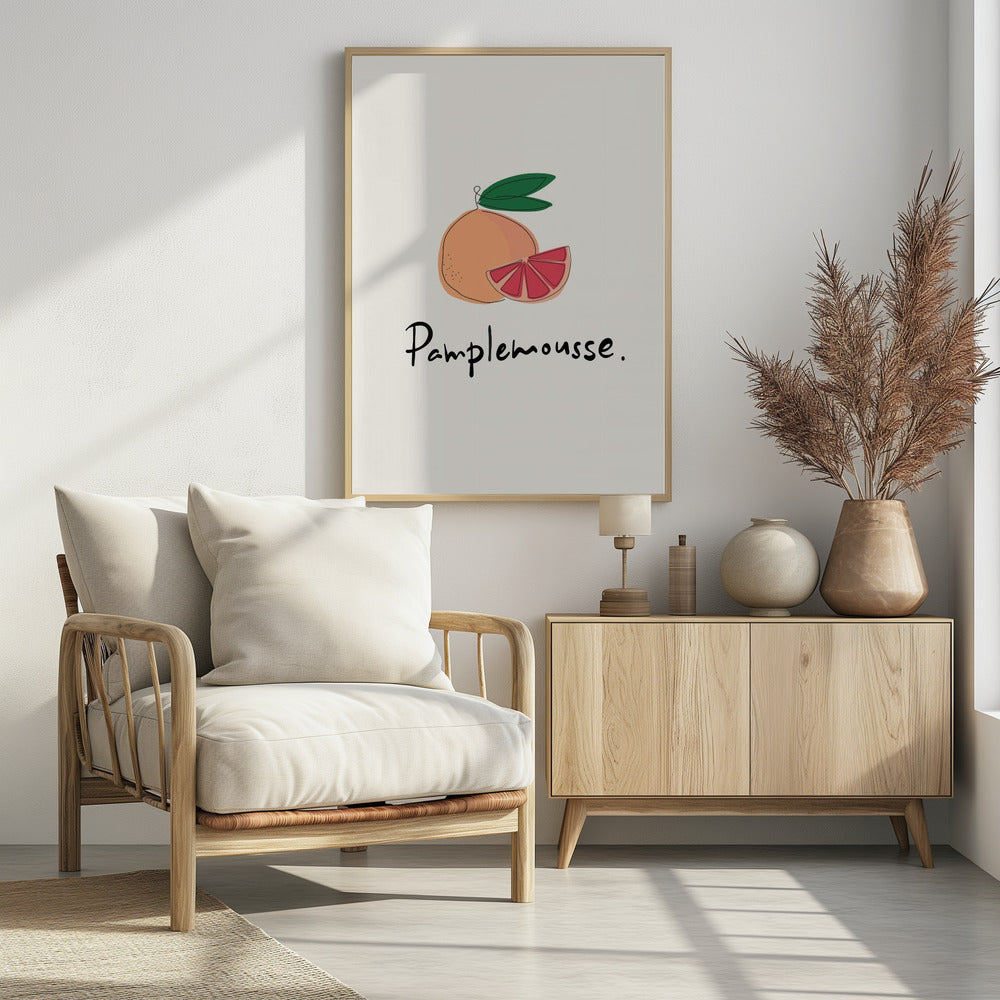 A minimalist art print featuring a stylized illustration of a whole grapefruit and a cut wedge. The fruit is peach-colored with a vibrant pink interior, topped with green leaves. Below the illustration, the French word 'Pamplemousse.' is written in a casual black script. The background is a soft off-white, and the print is enclosed in a simple black frame. Wall Art