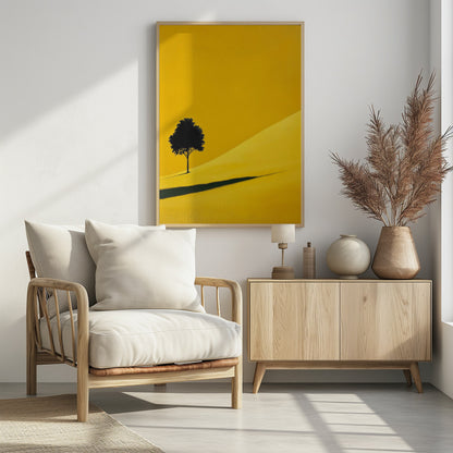 A minimalist painting of a single black tree on a vibrant yellow, rolling hill, casting a long, dark shadow. The background is a solid yellow, creating a stark, modern landscape scene within a black frame. Print