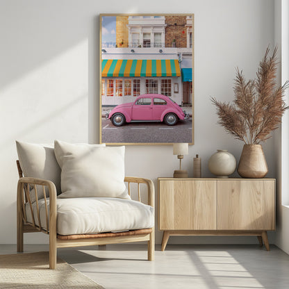 A vibrant, eye-level photograph of a vintage pink Volkswagen Beetle parked on a city street in front of a charming white storefront with a bold yellow and teal striped awning. Wall Art