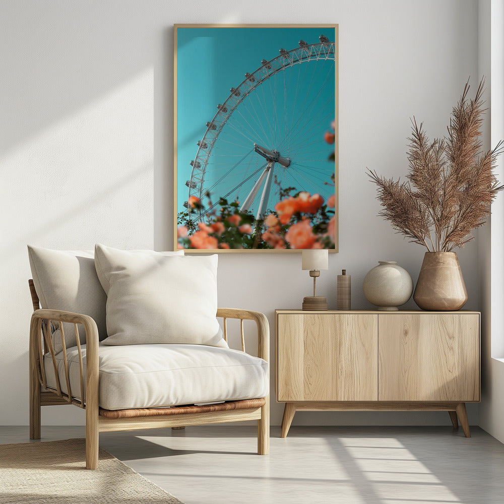 A low-angle shot of the London Eye ferris wheel against a clear, vibrant teal sky. In the foreground, out-of-focus orange flowers create a soft, colorful frame. Poster