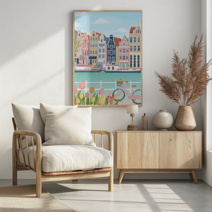 A vibrant illustration of a classic Amsterdam scene, featuring a row of colorful, traditional canal houses next to a turquoise waterway with boats. In the foreground, a pink bicycle with a basket of flowers stands near a bed of pink and yellow tulips. Print