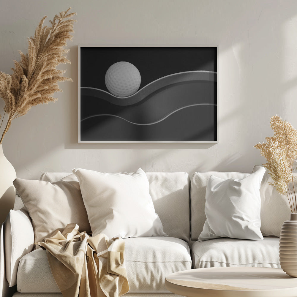A framed, minimalist black and white photograph of a golf ball resting on a gracefully curving gray surface against a solid black background. Wall Art