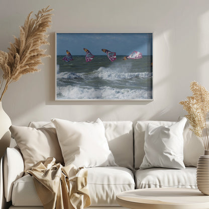 A composite, silver-framed photograph capturing the four stages of a windsurfer's impressive jump over choppy, white-capped ocean waves under a partly cloudy blue sky. Print