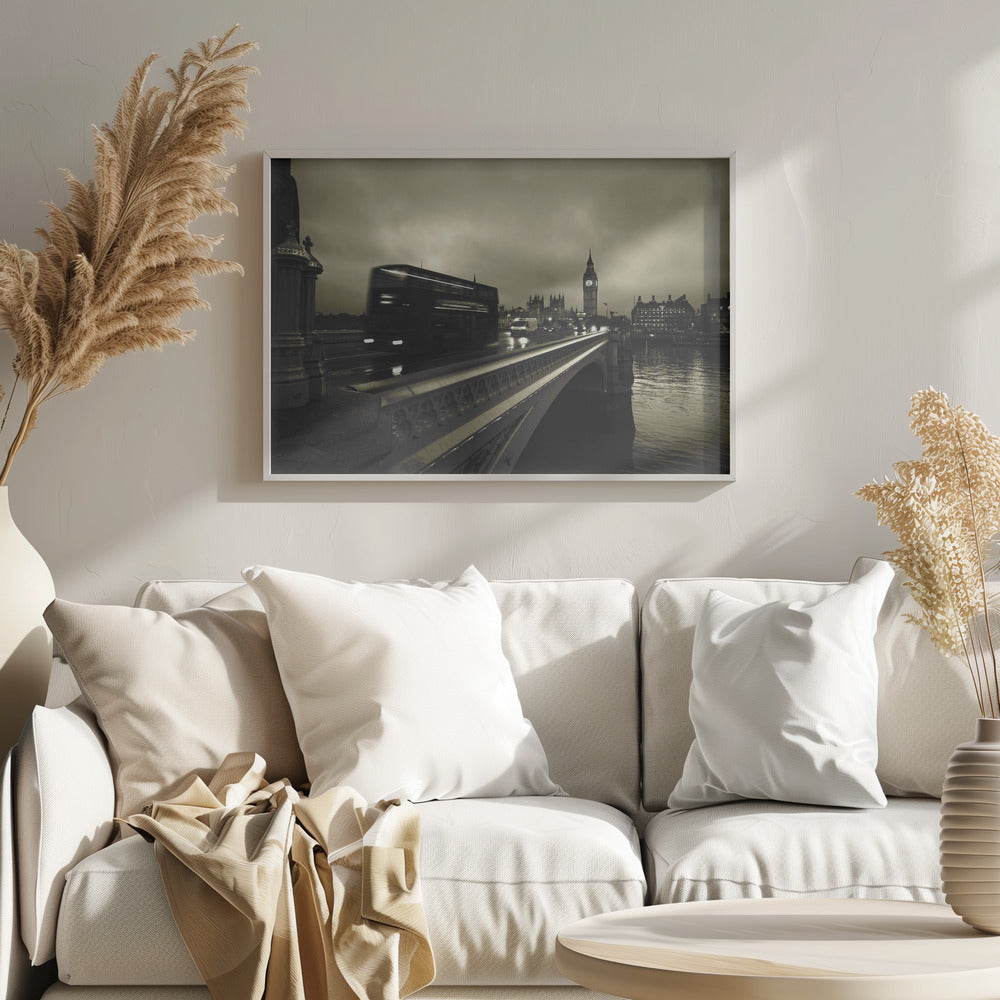 A framed, sepia-toned long-exposure photograph of London. A double-decker bus is shown in motion blur as it crosses Westminster Bridge. In the background, the Big Ben clock tower and the Houses of Parliament are visible against a cloudy sky, with lights reflecting on the wet road and the River Thames. Wall Art