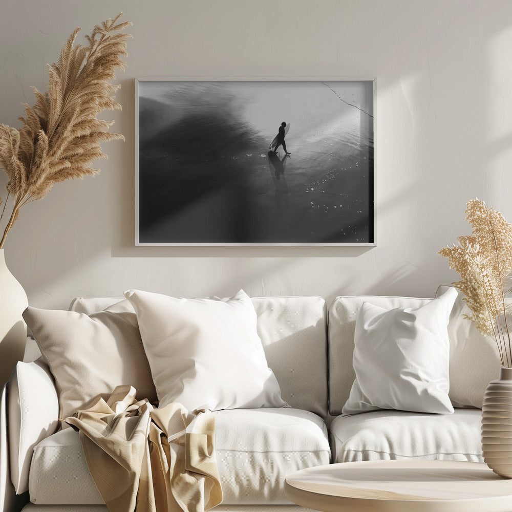 A high-contrast, black and white photograph of a surfer silhouetted against the bright reflection of the sun on the water. The surfer is carrying a surfboard and walking along the wet sand, leaving footprints behind. Their long shadow is cast in front of them on the dark, glistening sand. Print