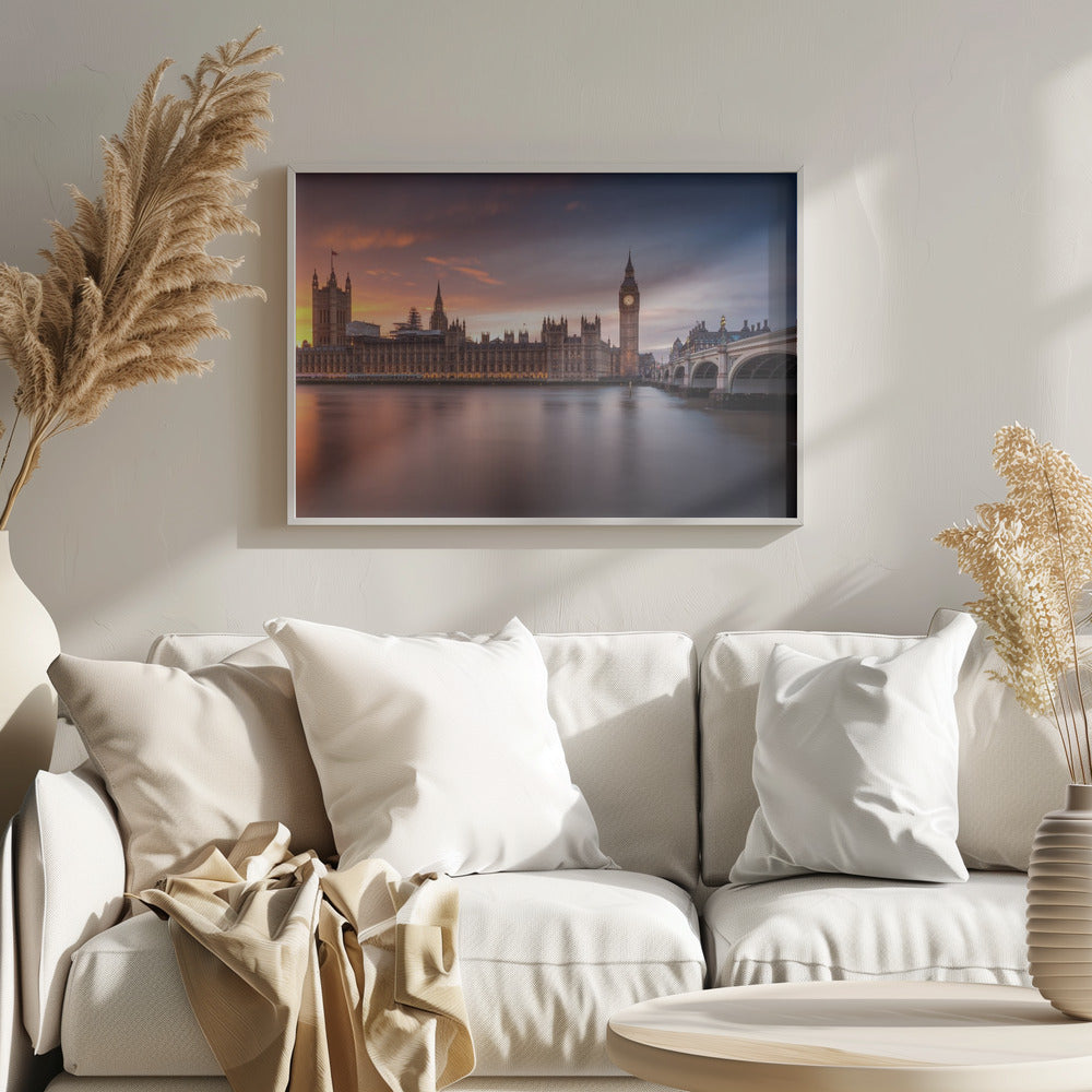 A framed photograph of the Houses of Parliament and Big Ben in London at sunset, with a dramatic orange and purple sky reflecting in the calm waters of the River Thames. Artwork