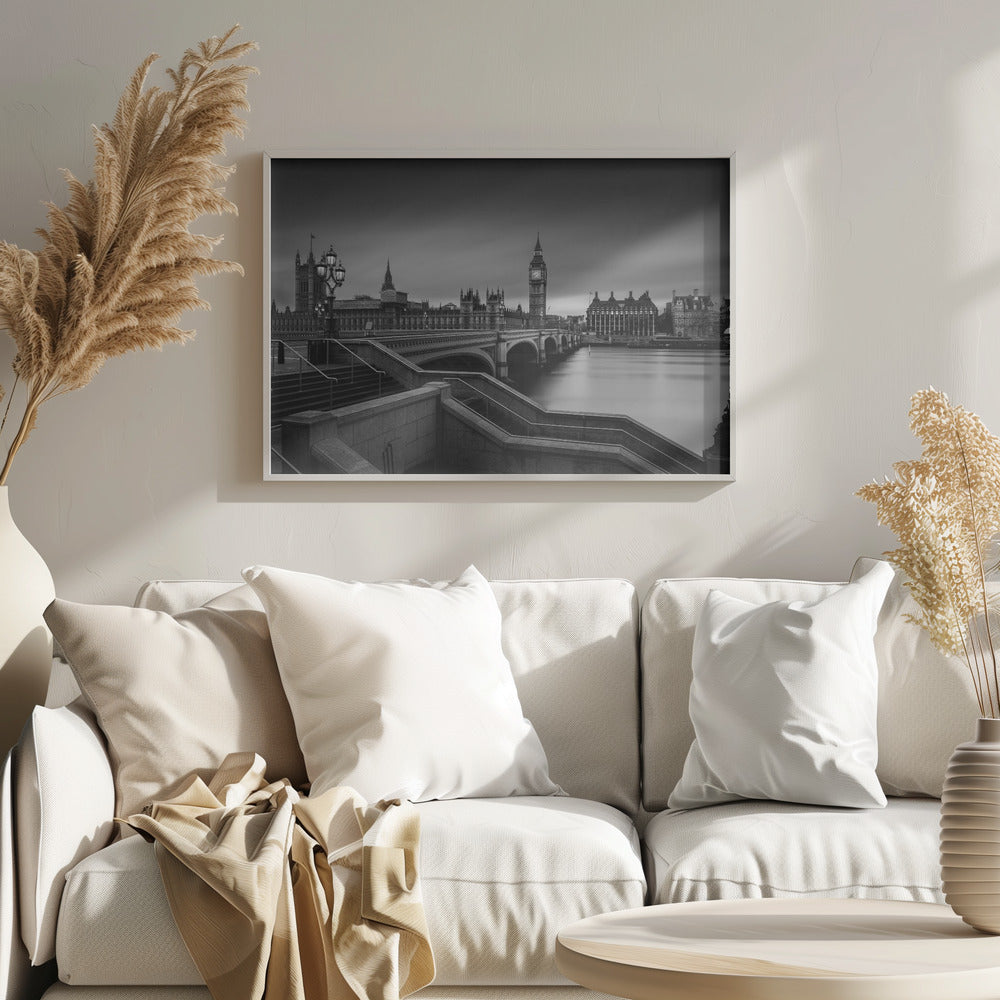 A framed, black and white, long-exposure photograph of the London skyline featuring the Houses of Parliament and the Big Ben clock tower across the River Thames. In the foreground, stone steps lead down towards Westminster Bridge, and the water of the river is smooth and reflective under a dark, cloudy sky. Print