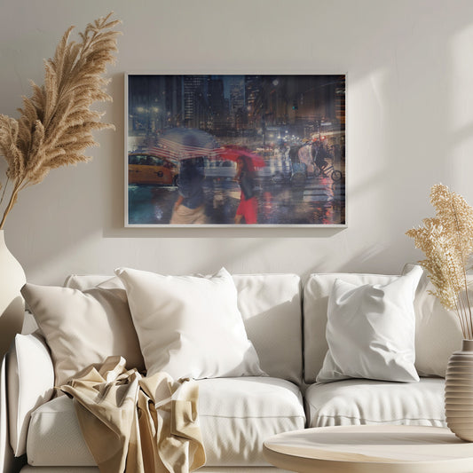 An artistic motion-blur photograph of a rainy night on East 42nd Street in New York City. Pedestrians with umbrellas, one with an American flag design and another bright red, cross the wet street as city lights and a yellow taxi reflect on the pavement, creating a vibrant, impressionistic scene within a silver frame. Decor