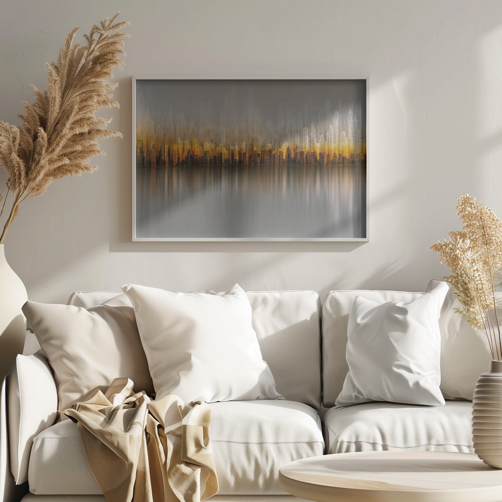 An abstract painting of a city skyline at sunset or sunrise, with buildings glowing in shades of gold, orange, and brown. The hazy, gray sky shows faint outlines of taller buildings in the background. The city is reflected in the water below, with the colors stretched into long, vertical streaks that blend into the gray foreground. The entire piece is enclosed in a simple silver frame. Wall Art