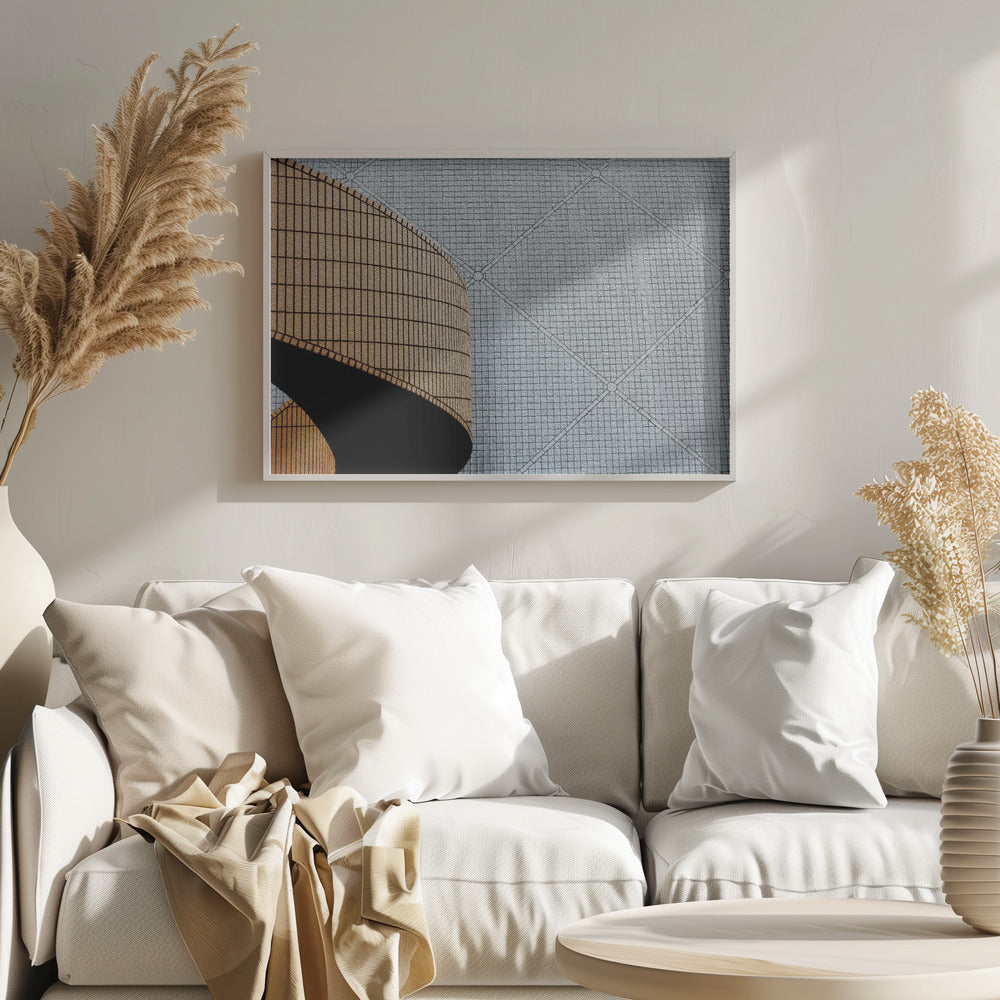 An abstract architectural image with a painterly texture, framed in gray. The composition features a curved wall of vertical brown tiles on the left, casting a sharp black shadow, juxtaposed with a flat surface of gray square tiles arranged in a grid with diagonal lines on the right. Artwork