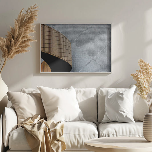 An abstract architectural image with a painterly texture, framed in gray. The composition features a curved wall of vertical brown tiles on the left, casting a sharp black shadow, juxtaposed with a flat surface of gray square tiles arranged in a grid with diagonal lines on the right. Artwork