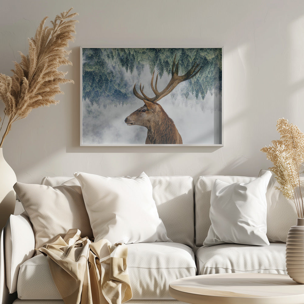 A surreal double-exposure style image featuring the profile of a brown stag with large antlers. The top half of the image is an inverted green pine forest that blends into a foggy, light grey background surrounding the deer. The entire artwork is presented within a silver frame. Poster