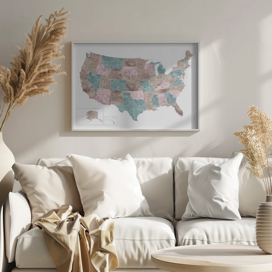 A stylized map of the United States in a silver frame. The states are colored with a marbled texture in alternating shades of muted brown, dusty pink, and teal. Each state is labeled, and the words 'UNITED STATES' are spaced across the country. Insets for Alaska and Hawaii are in the bottom left corner. Artwork