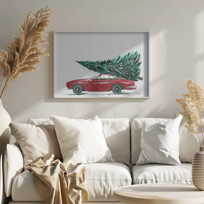 A festive painting of a vintage red sports car with a large green Christmas tree tied to its roof. The car is depicted in profile against a plain white background, and the artwork is displayed in a simple silver frame. Decor