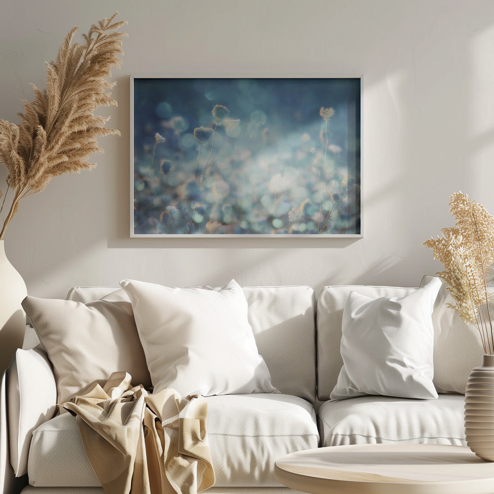 A dreamy, soft-focus photograph of dried wildflowers silhouetted against a shimmering background of blue and white bokeh lights, creating a magical and ethereal atmosphere. The artwork is presented in a brushed silver frame. Wall Art