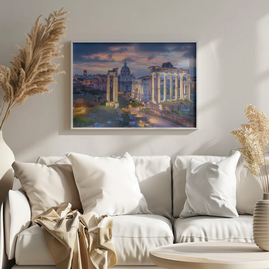 A scenic photograph of the ancient Roman Forum in Rome, Italy, at dusk. The ruins, including prominent columns and arches, are illuminated by warm lights, contrasting with the deep blue and vibrant pink of the sunset sky. Wall Art