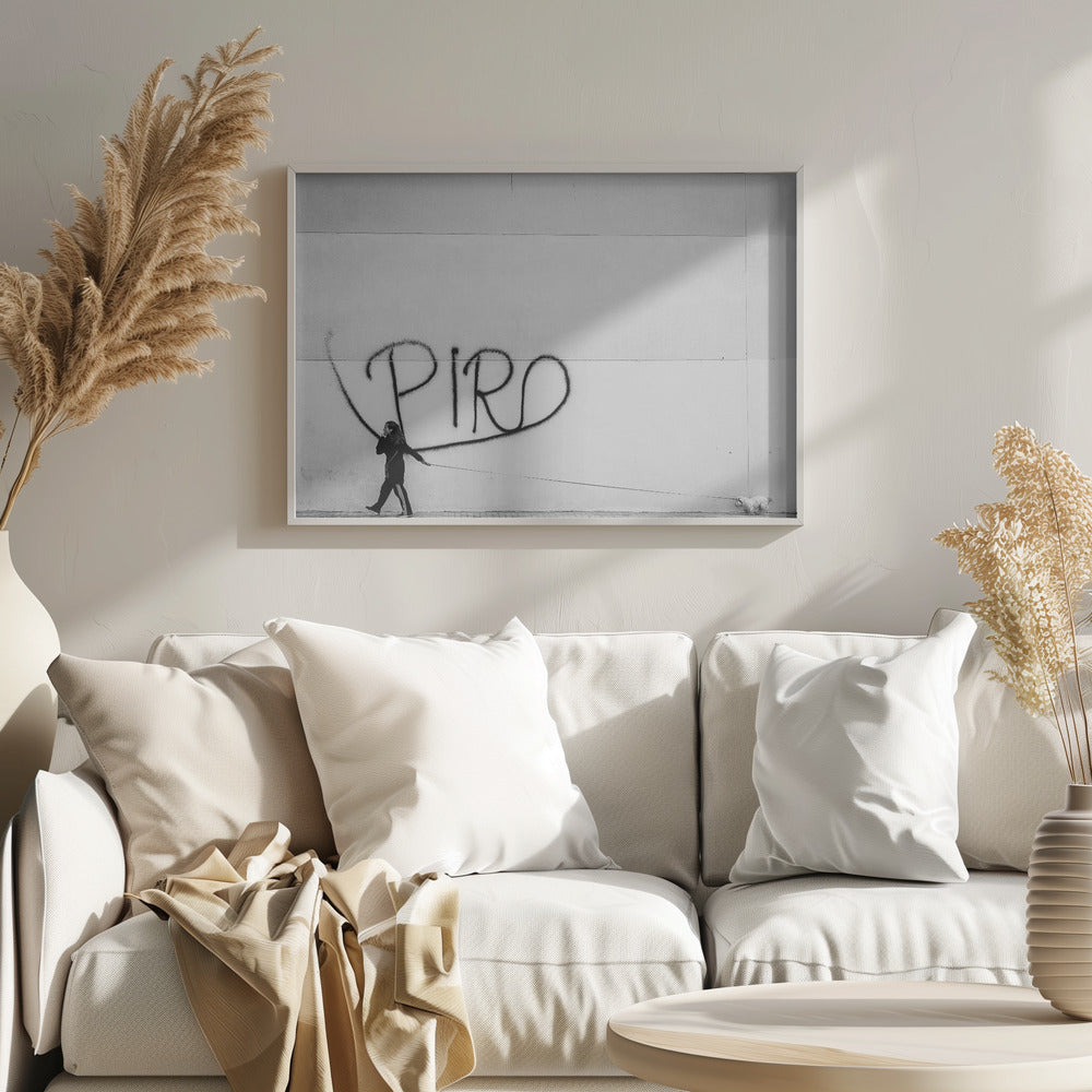 A minimalist black and white photograph of a woman dressed in black walking a small, fluffy white dog on a long leash. They are walking along a sidewalk in front of a large, pale wall with the word 'PIRO' written in black spray paint graffiti. The entire image is enclosed in a light grey frame. Poster