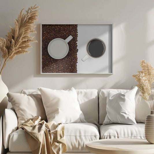 A top-down, split-screen photograph showing a contrast between coffee and milk. On the left, a white mug of milk sits on a bed of roasted coffee beans. On the right, a white mug of black coffee rests on a clean white background, creating a stark visual divide. Artwork