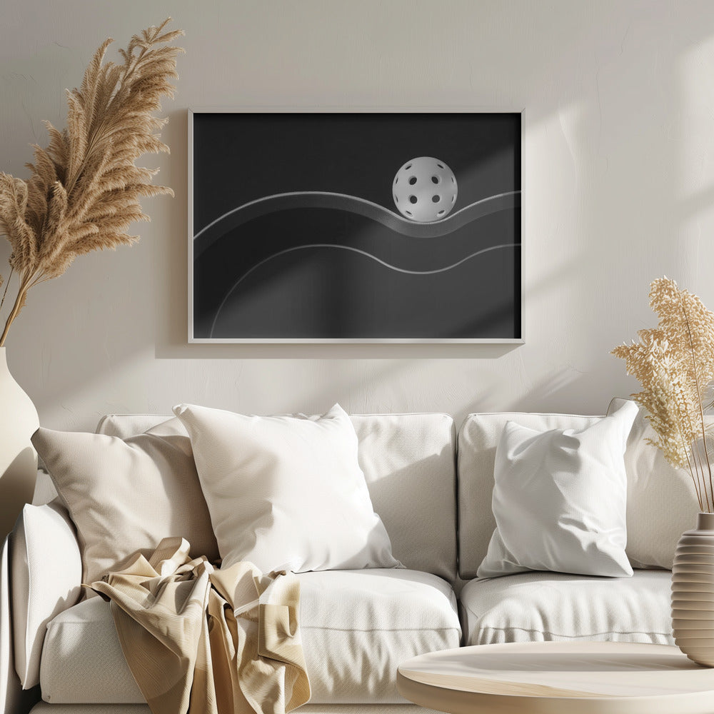 A minimalist black and white photograph of a white pickleball resting perfectly balanced on a thick, wavy, textured line against a solid black background. Below it, a thin white line mimics the curve. The entire piece is framed in silver. Poster