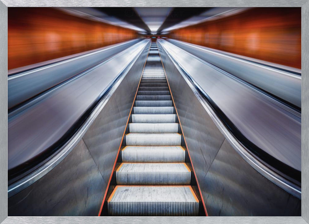 A symmetrical, low-angle photograph looking up a very long escalator, creating a strong sense of perspective towards a vanishing point. The orange walls are motion-blurred, suggesting speed, while the metallic steps in the center remain clear. Decor