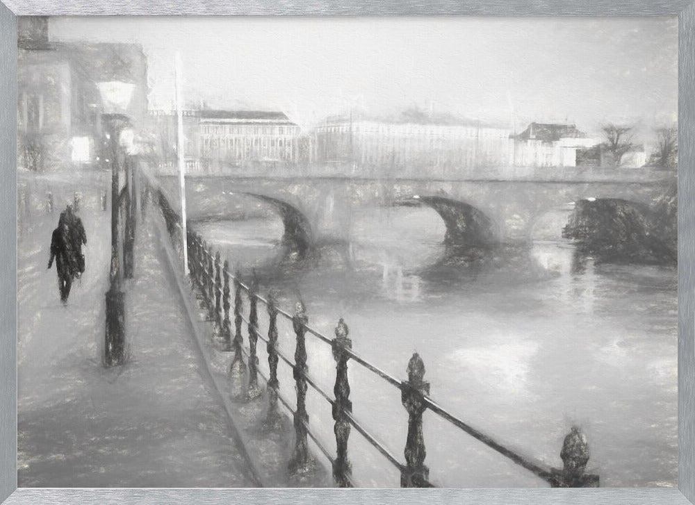 A framed, black and white impressionistic artwork of a city scene on a foggy or rainy day. In the foreground, a dark metal railing runs along a riverside walkway where a person in a dark coat is walking. An arched stone bridge crosses the river in the midground, with hazy buildings visible in the background, creating a moody and atmospheric scene. Wall Art