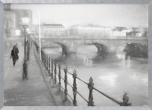 A framed, black and white impressionistic artwork of a city scene on a foggy or rainy day. In the foreground, a dark metal railing runs along a riverside walkway where a person in a dark coat is walking. An arched stone bridge crosses the river in the midground, with hazy buildings visible in the background, creating a moody and atmospheric scene. Wall Art