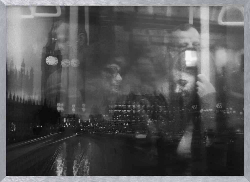 A moody black and white double exposure photograph showing a rainy London street at night with Big Ben, overlaid with the faint reflections of people inside a moving vehicle like a bus. The image has a dreamy, layered effect and is displayed in a silver frame. Print
