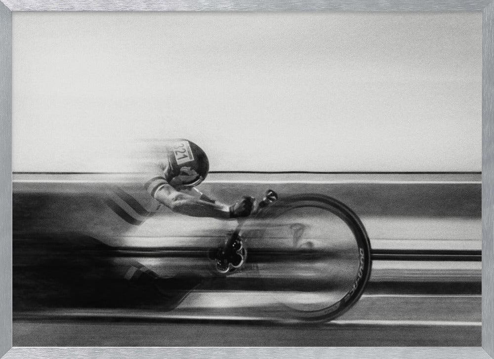 A black and white photograph captured with motion blur, showing a cyclist in an aerodynamic position racing at high speed. The background is blurred into horizontal lines, emphasizing the velocity. The image is enclosed in a silver frame. Wall Art